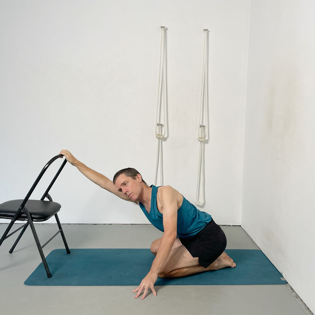 Parivrtta Adho Mukha Virasana (Twisting Downward Facing Hero Pose) Using a Chair