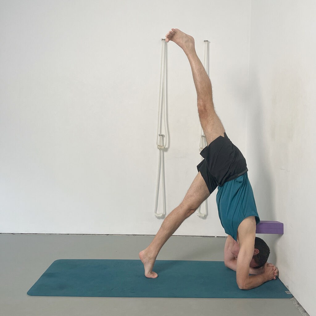 headstand preparation leg raises with block support