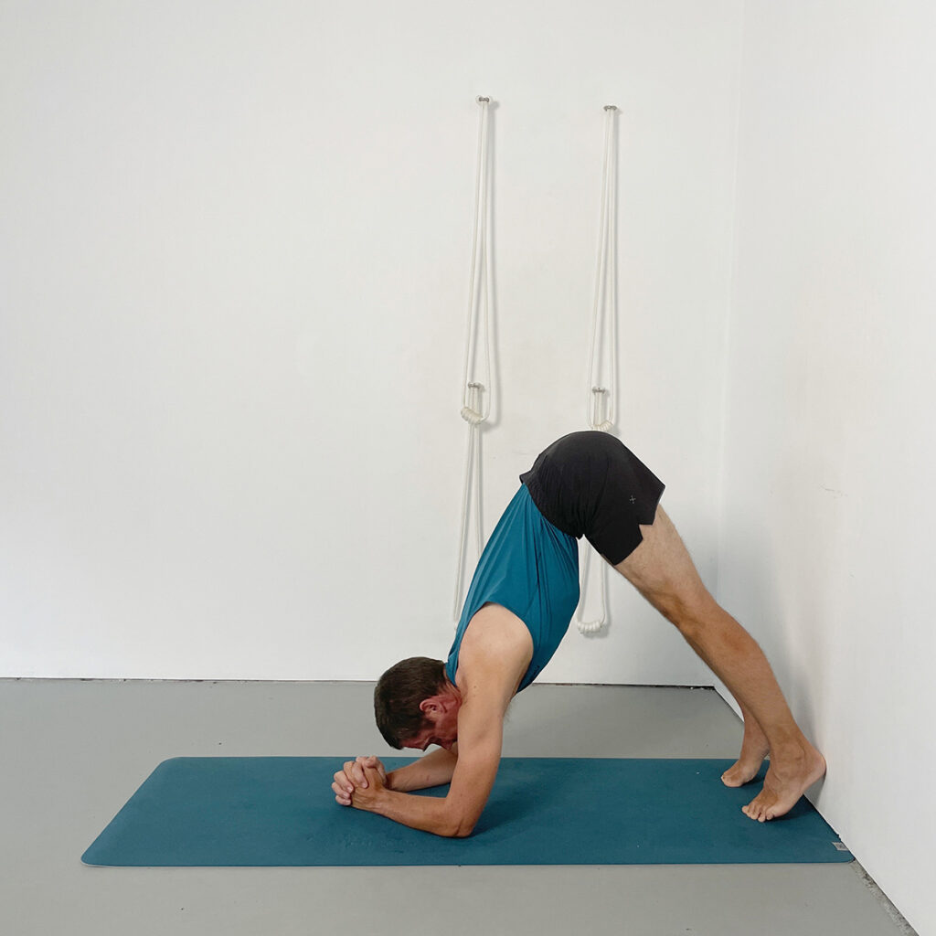 headstand preparation with feet to the floor